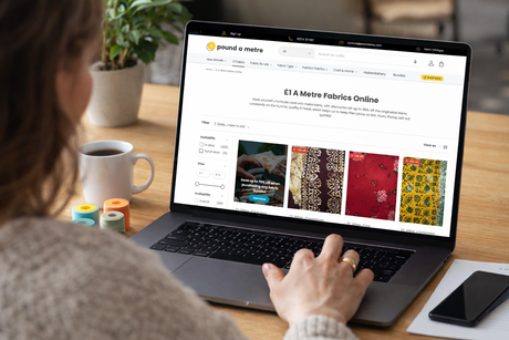 Woman browsing the Pound A Metre £1 fabrics page on a laptop, preparing to order fabric onlin