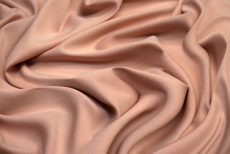 Light pink Rayon fabric laid out in a swirling texture.